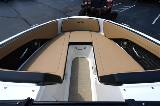 Slide: The Image of 2025 Sea Ray SPX 190 boat interior with tan seating and sleek design. - 8