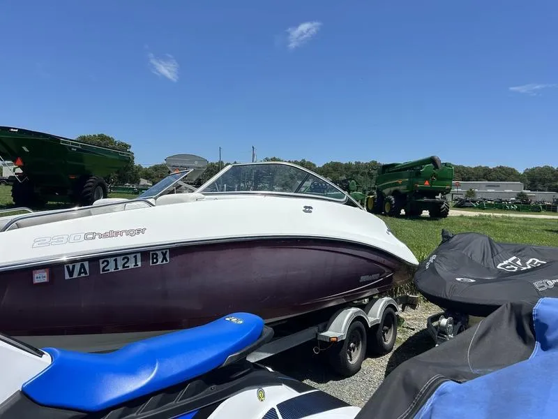 Slide: The Image of 2022 Sea-Doo Sport Boats 230 Challenger on trailer under clear blue sky. - 3