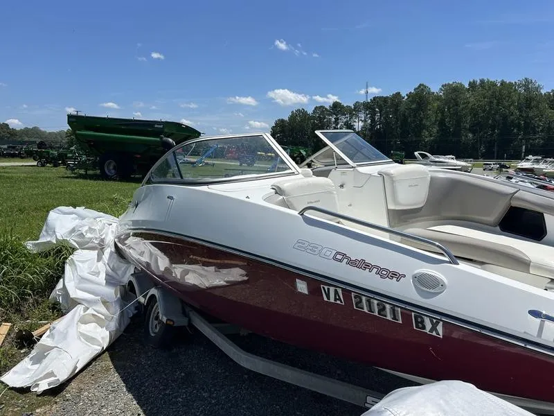 Slide: The Image of 2022 Sea-Doo 230 Challenger boat parked outdoors on a sunny day. - 4