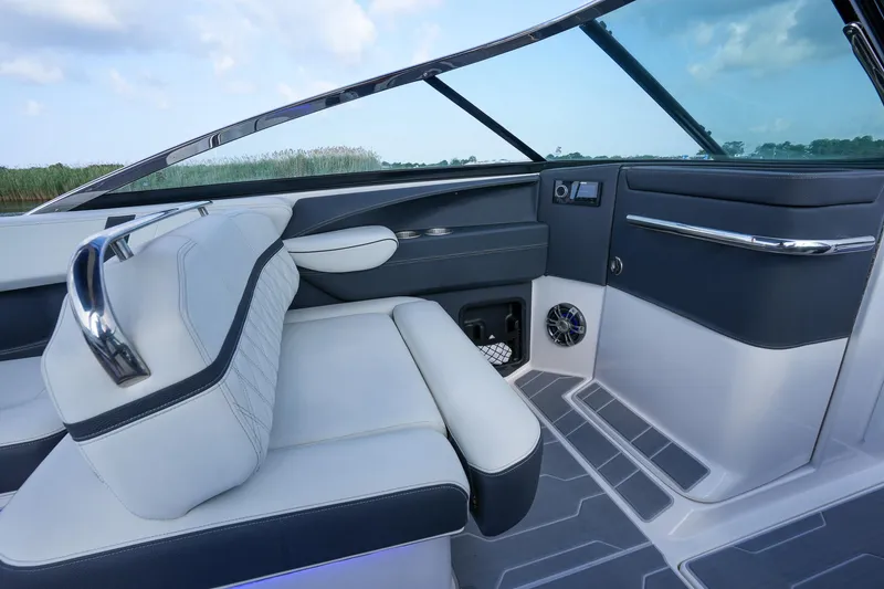 Slide: The Image of 2023 Regal 29 OBX boat interior with sleek seating and modern dashboard design. - 15