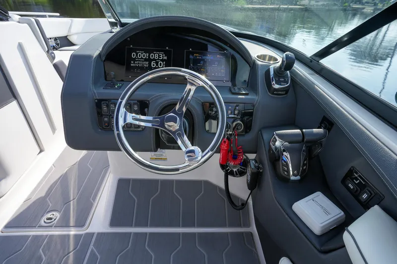 Slide: The Image of 2023 Regal 29 OBX boat dashboard with steering wheel and control panel. - 19