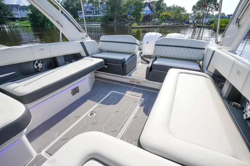 Slide: The Image of 2023 Regal 29 OBX boat interior with luxurious seating and scenic waterfront view. - 20