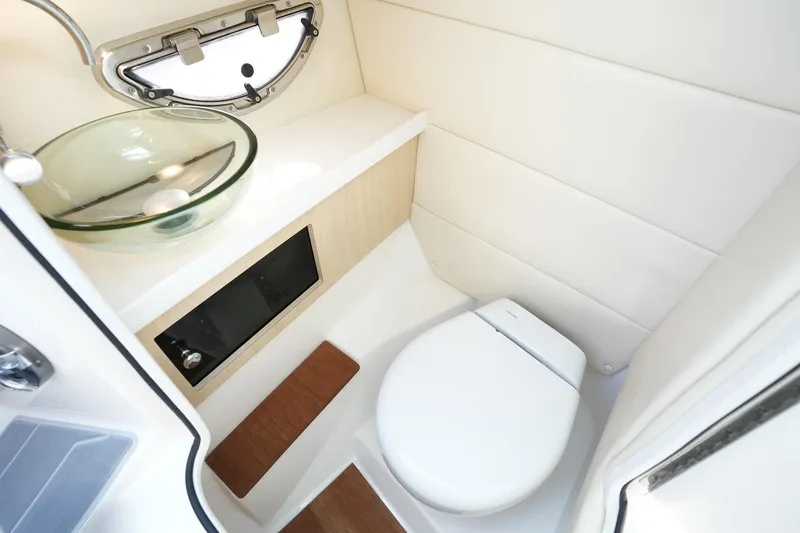 Slide: The Image of 2023 Regal 29 OBX boat bathroom with modern glass sink and compact toilet. - 25