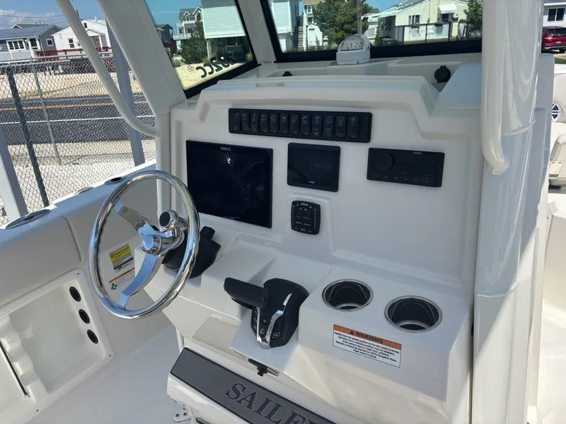 Slide: The Image of Helm of 2026 Sailfish 232 CC boat with steering wheel and control panel. - 11
