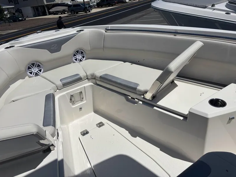 Slide: The Image of 2026 Sailfish 232 CC boat interior with cushioned seating and cup holders. - 4
