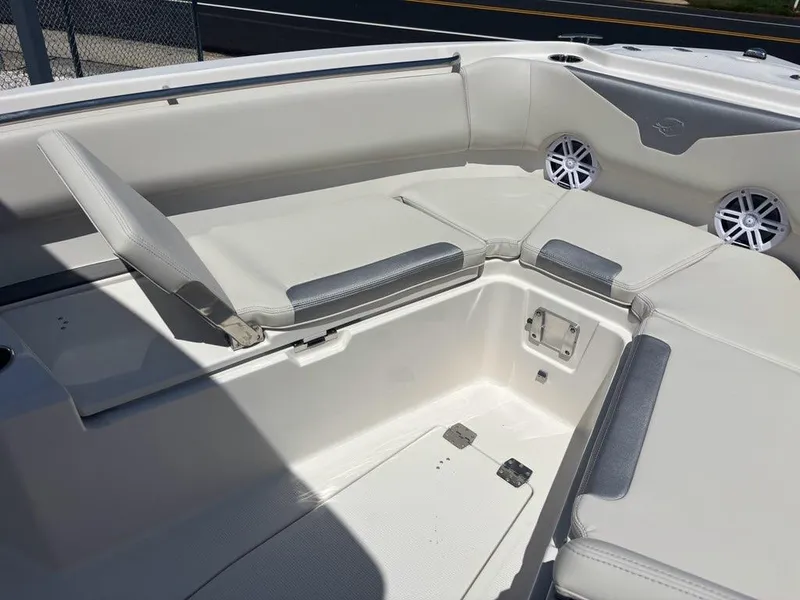 Slide: The Image of 2026 Sailfish 232 CC boat interior with cushioned seating and built-in speakers. - 5
