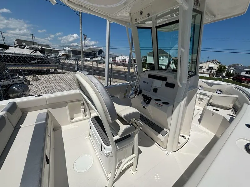 Slide: The Image of 2026 Sailfish 232 CC boat interior with helm, seating, and modern controls. - 8