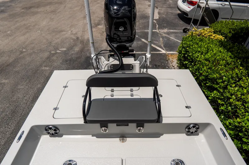 Slide: The Image of 2021 SCB S22 boat deck with seating and motor, parked outdoors. - 20