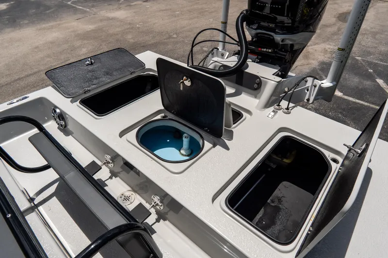 Slide: The Image of 2021 SCB S22 boat deck with open storage compartments and motor, showcasing functionality. - 22