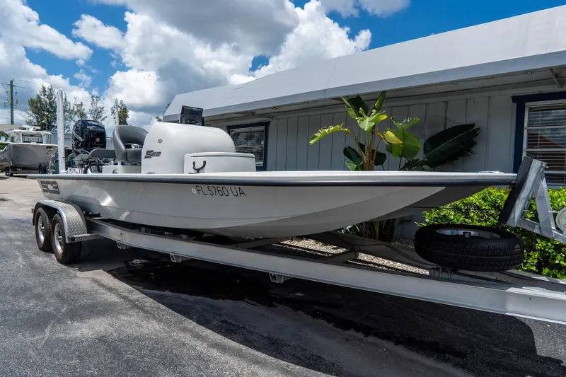 Slide: The Image of 2021 SCB S22 boat on trailer, parked outdoors under a cloudy sky. - 4