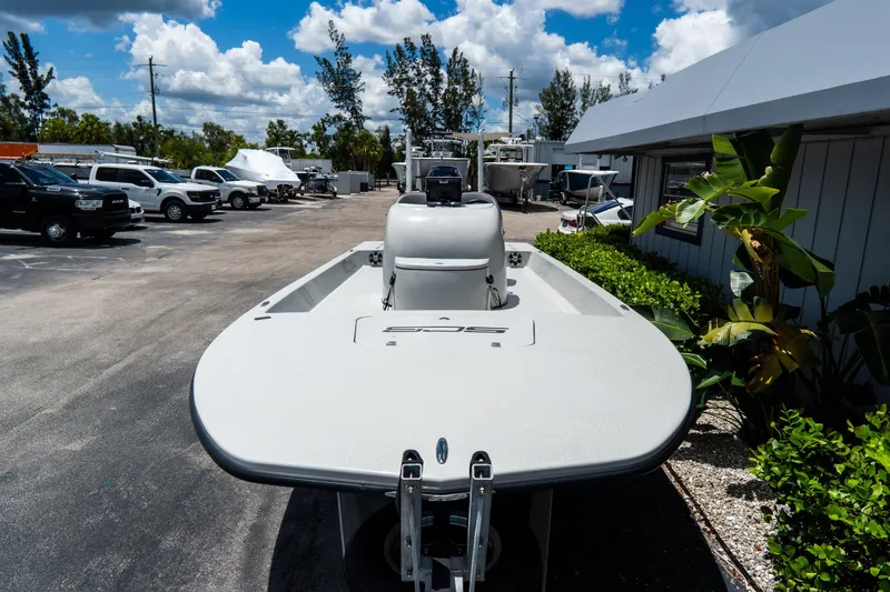 Slide: The Image of 2021 SCB S22 boat in a parking lot, surrounded by vehicles and greenery. - 5