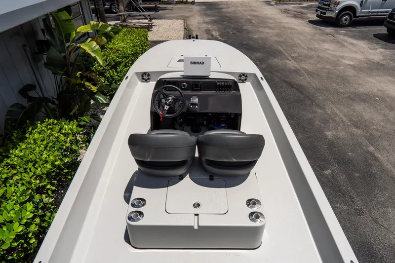 Slide: The Image of 2021 SCB S22 boat interior with dual seats and steering console, parked outdoors. - 9