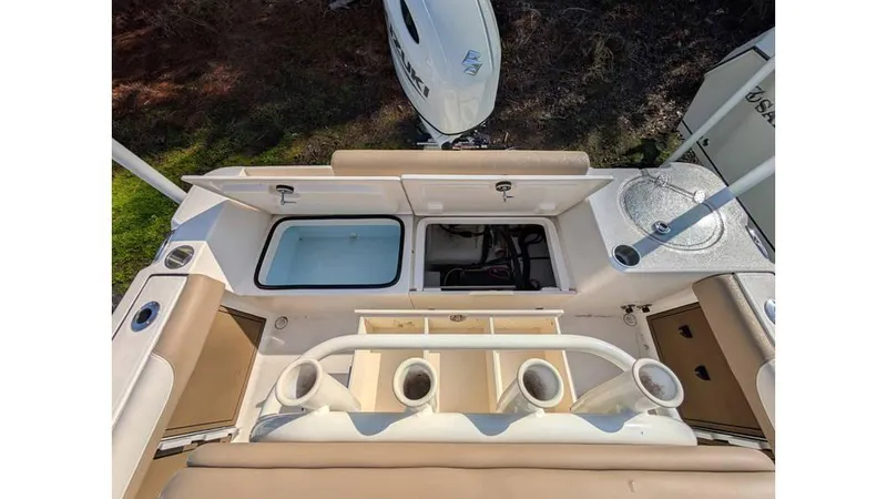 Slide: The Image of 2024 Sea Born LX22 Center Console boat interior with storage compartments and rod holders. - 4