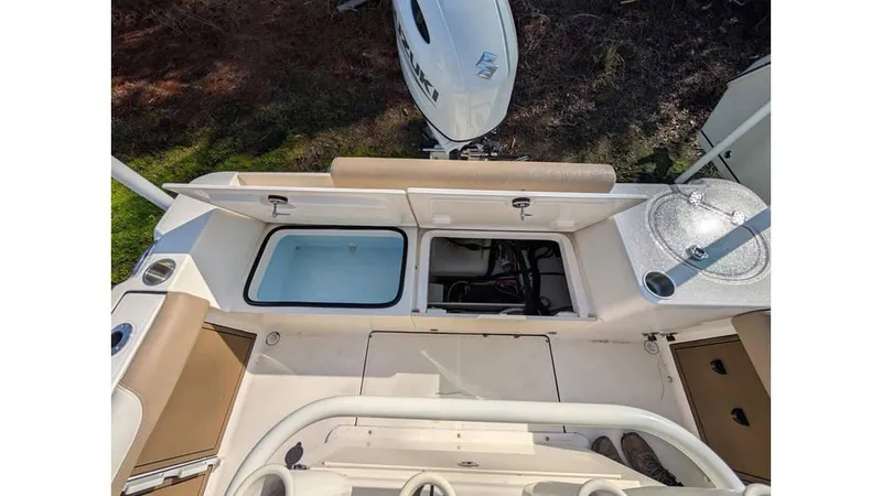 Slide: The Image of 2024 Sea Born LX22 Center Console boat interior with storage compartments and seating. - 6