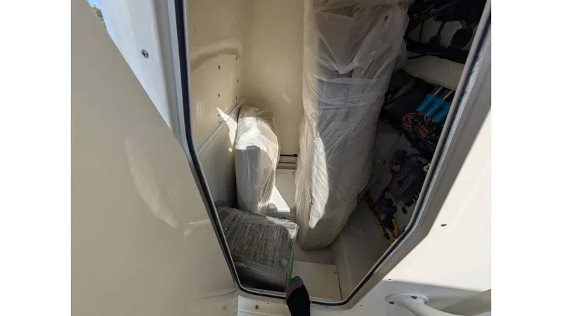 Slide: The Image of 2024 Sea Born LX22 Center Console interior storage area with wrapped equipment. - 9