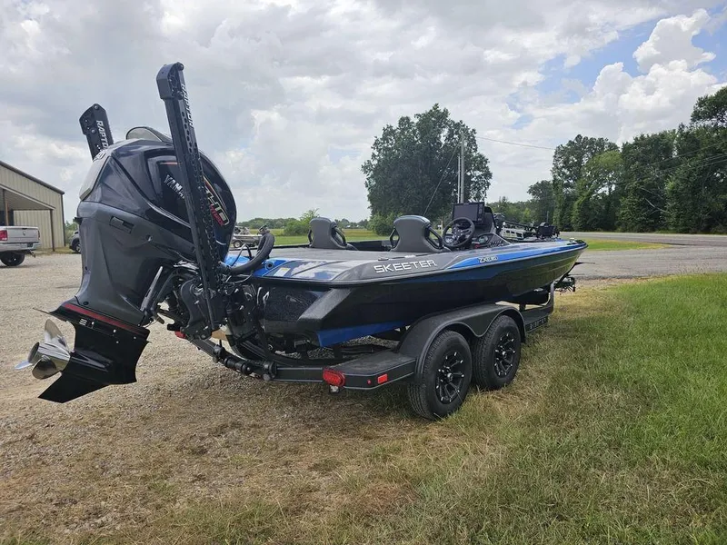 Slide: The Image of 2026 Skeeter ZXE20 boat on trailer, parked outdoors under cloudy sky. - 10