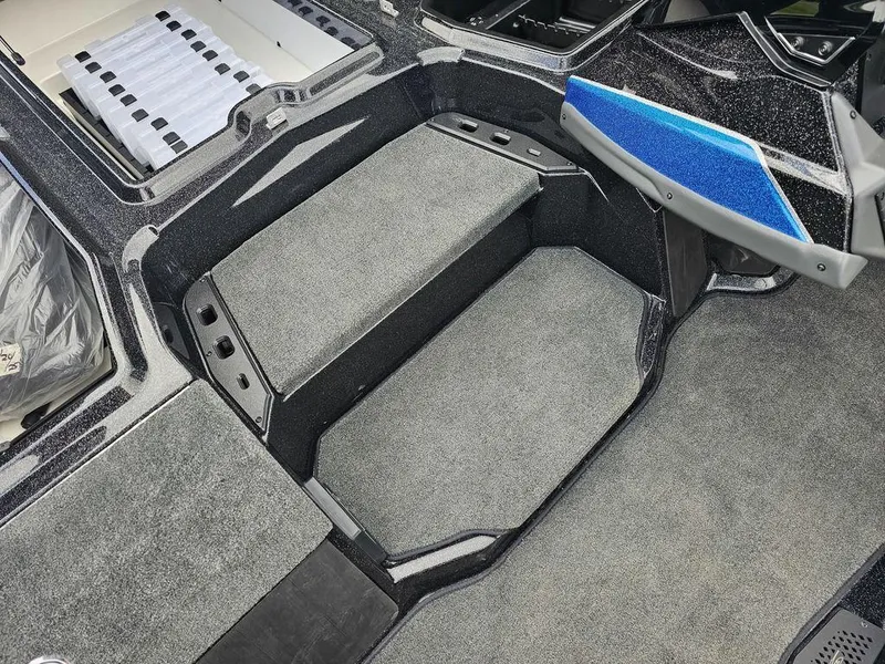 Slide: The Image of Interior of 2026 Skeeter ZXE20 boat with carpeted flooring and storage compartments. - 13