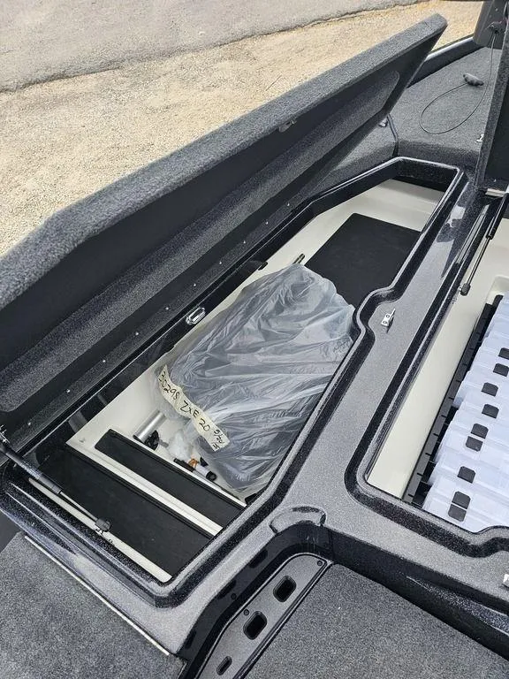 Slide: The Image of Open storage compartment in 2026 Skeeter ZXE20 boat, showing organized interior space. - 15