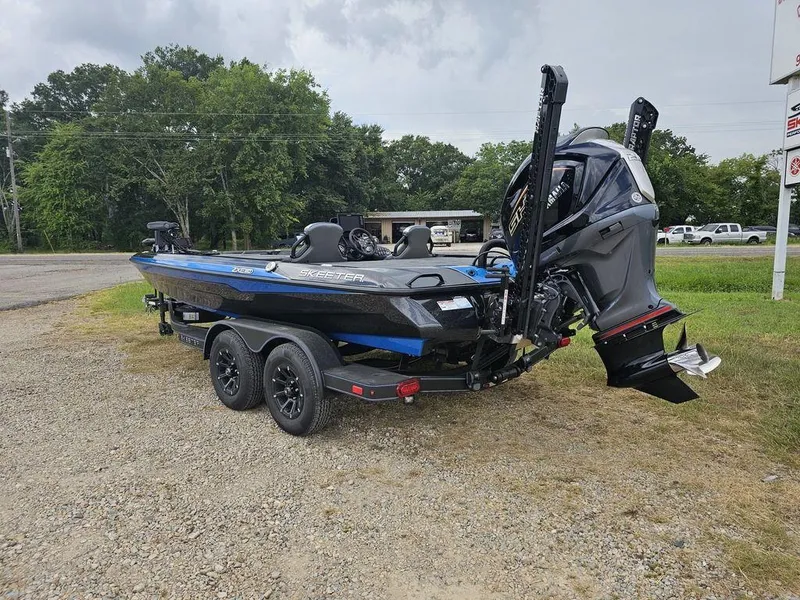 Slide: The Image of 2026 Skeeter ZXE20 boat on trailer, parked outdoors, showcasing sleek design and powerful engine. - 4