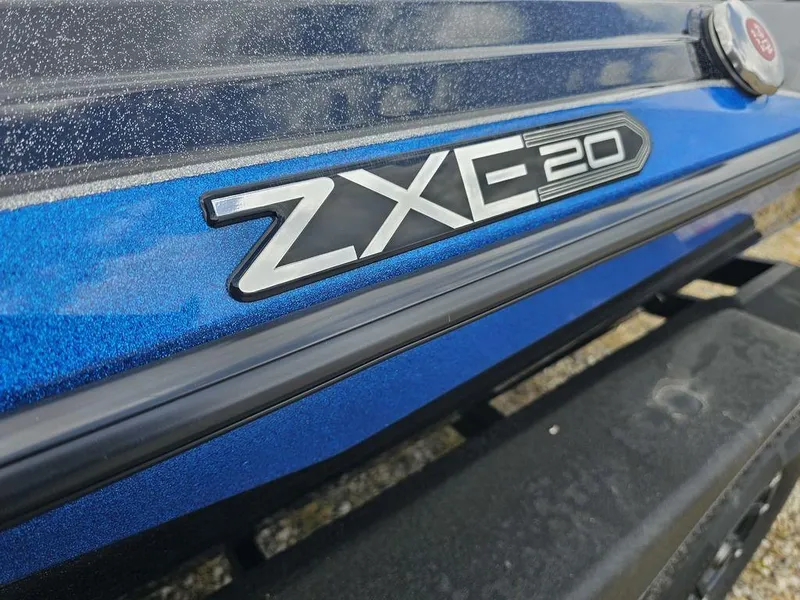 Slide: The Image of 2026 Skeeter ZXE20 boat emblem on metallic blue surface. - 5