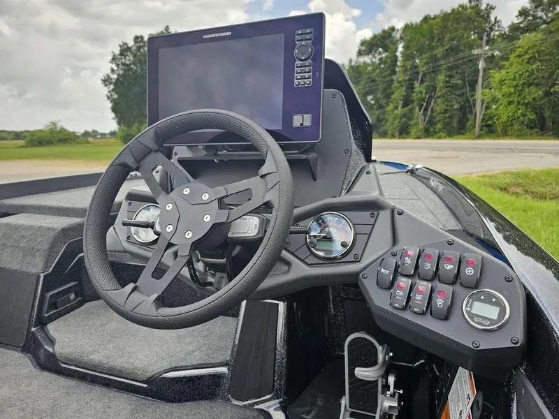 Slide: The Image of 2026 Skeeter ZXE20 boat dashboard with steering wheel and electronic controls. - 9