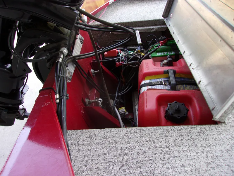 Slide: The Image of Open compartment of 2020 Bass Tracker 160 PRO showing fuel tank and wiring. - 12