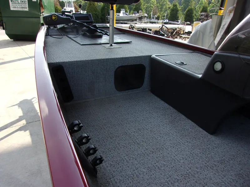 Slide: The Image of 2020 Bass Tracker 160 PRO boat interior with carpeted deck and control panel. - 5
