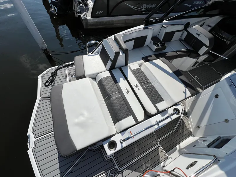 Slide: The Image of 2019 Monterey M6 boat with luxurious seating and sleek design at a dock. - 4