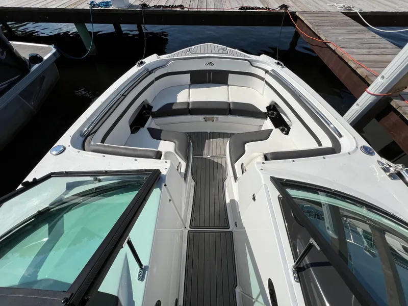 Slide: The Image of 2019 Monterey M6 boat interior with sleek seating and modern design at dock. - 8