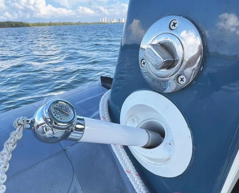 Slide: The Image of Protector Targa 28 boat water inlet and hose, ocean background, 2000 model. - 11