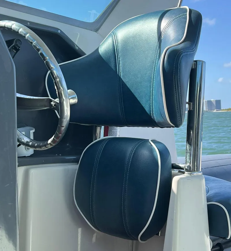 Slide: The Image of Steering wheel and seat of a 2000 Protector Targa 28 boat, with ocean view. - 14