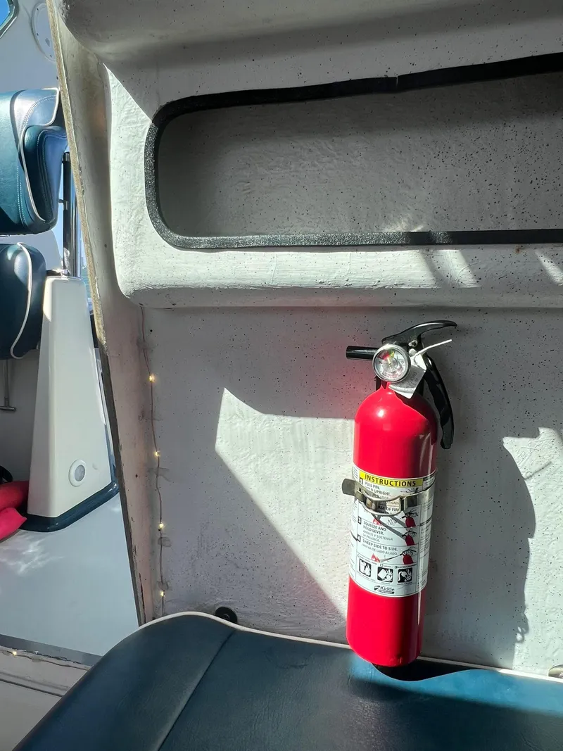 Slide: The Image of Fire extinguisher mounted inside a 2000 Protector Targa 28 boat cabin. - 31