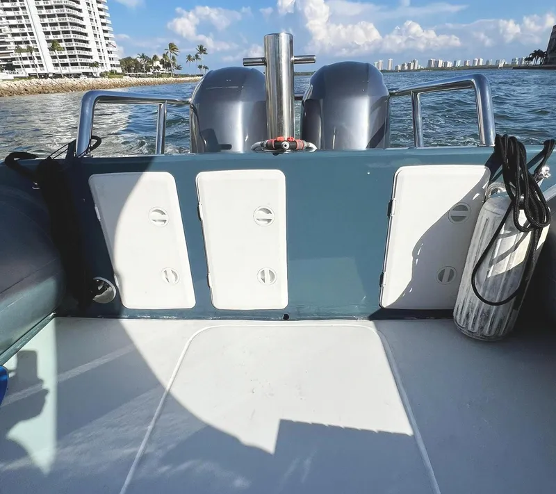 Slide: The Image of Rear view of a 2000 Protector Targa 28 boat with dual engines on water. - 7