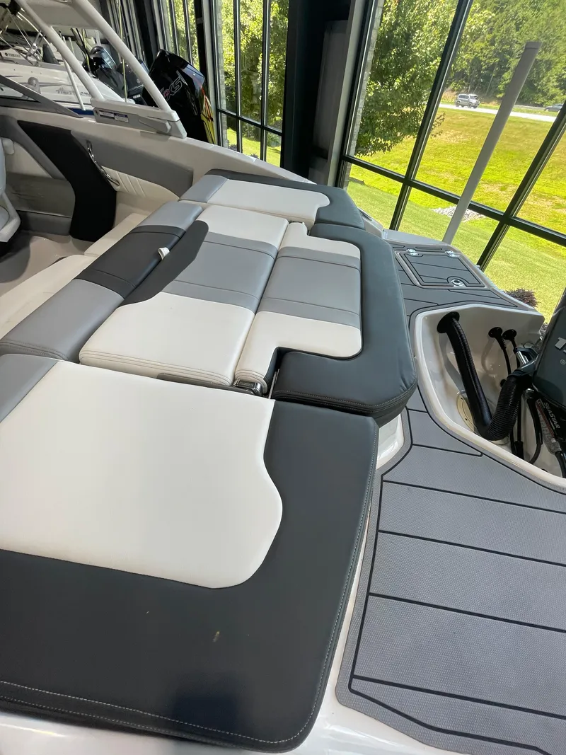 Slide: The Image of 2023 Chaparral 21 SSi OB boat interior with cushioned seating and modern design. - 10