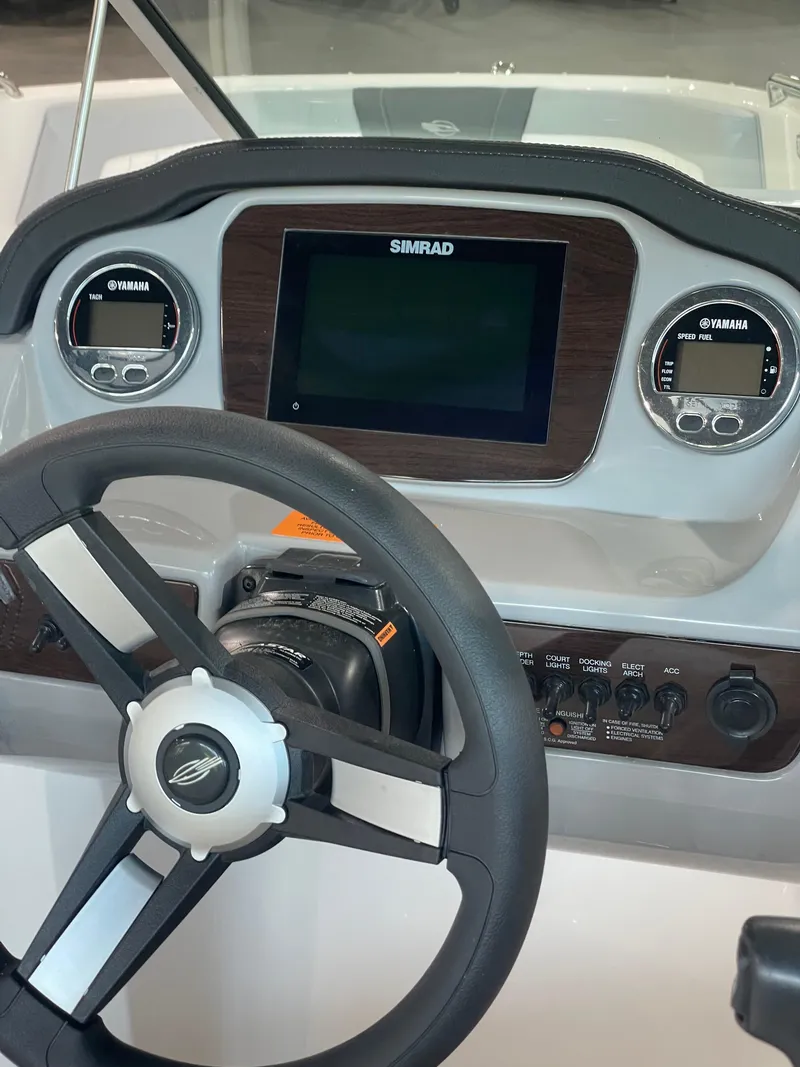 Slide: The Image of Dashboard of 2023 Chaparral 21 SSi OB boat with Simrad display and Yamaha gauges. - 13