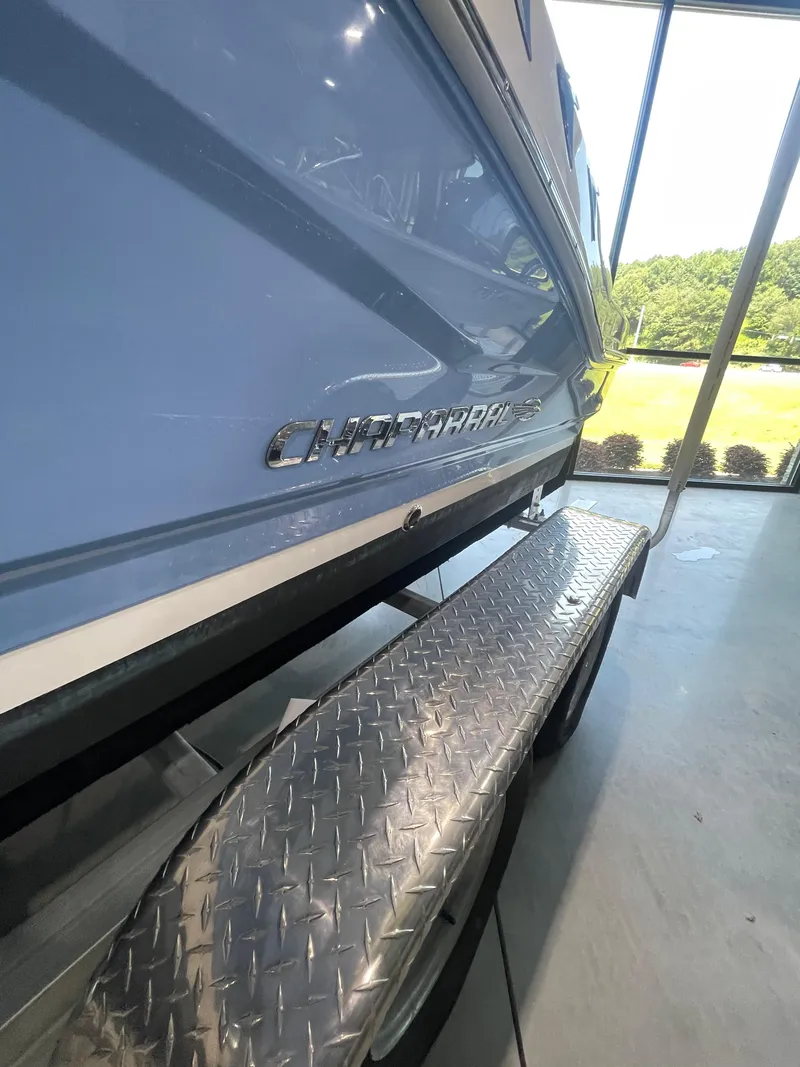 Slide: The Image of 2023 Chaparral 21 SSi OB boat on trailer, side view in showroom. - 7