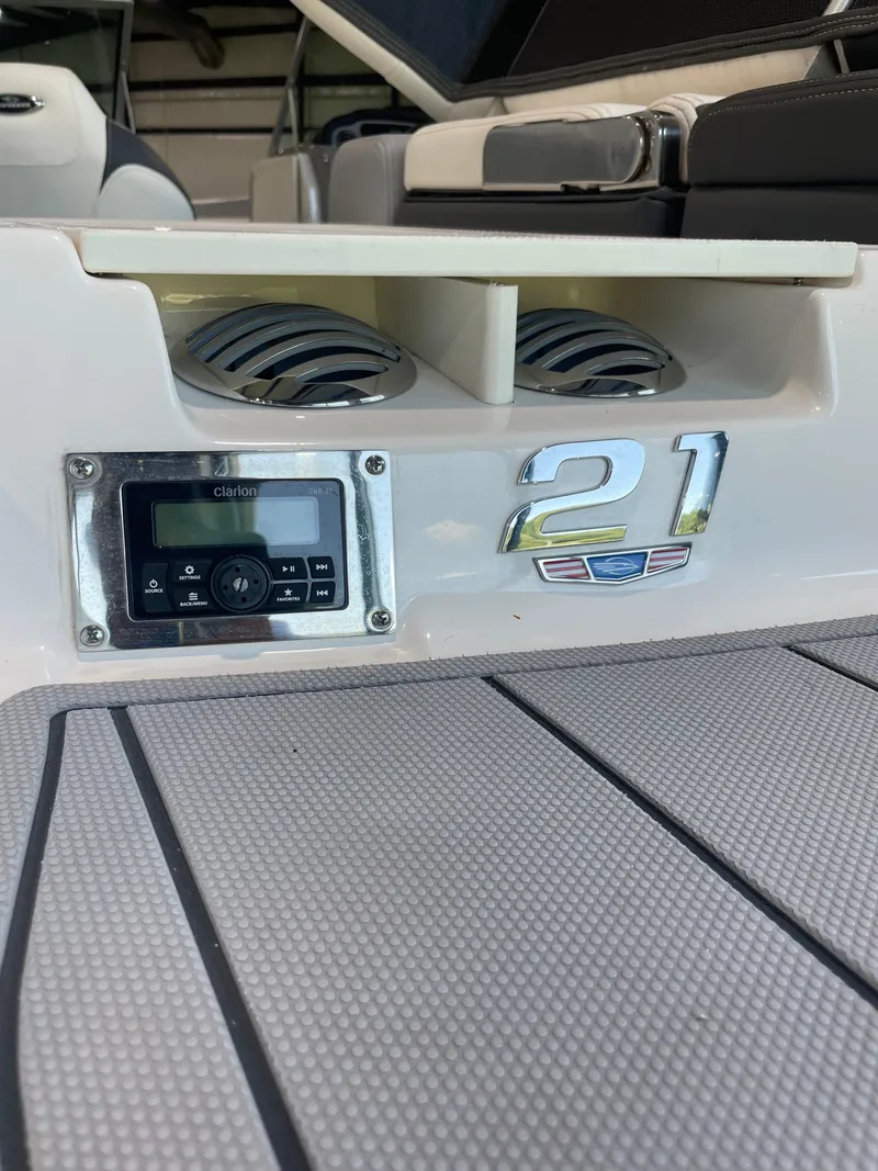 Slide: The Image of 2023 Chaparral 21 SSi OB boat deck with audio system and model emblem. - 8