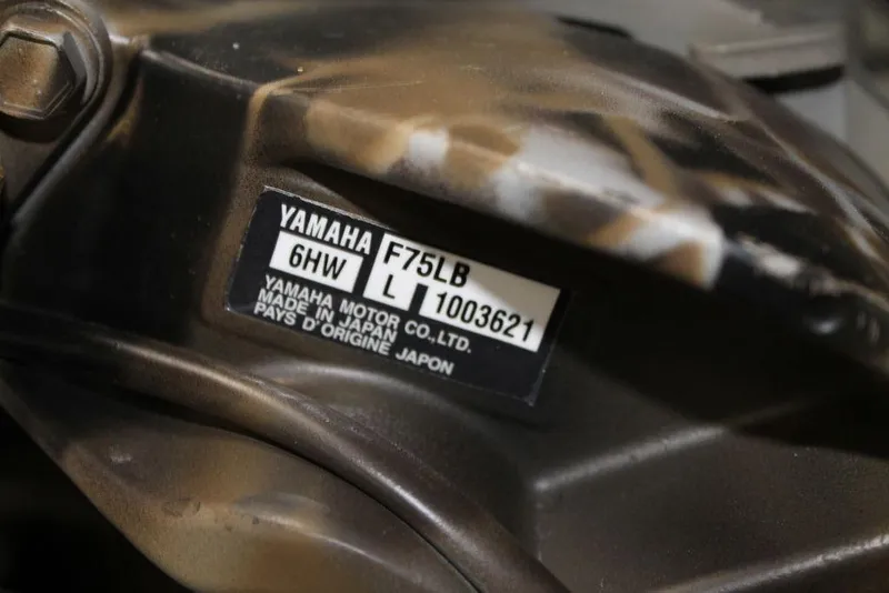 Slide: The Image of 2026 Excel 1860 Viper F4 boat with camouflage design on a trailer in showroom. - 2