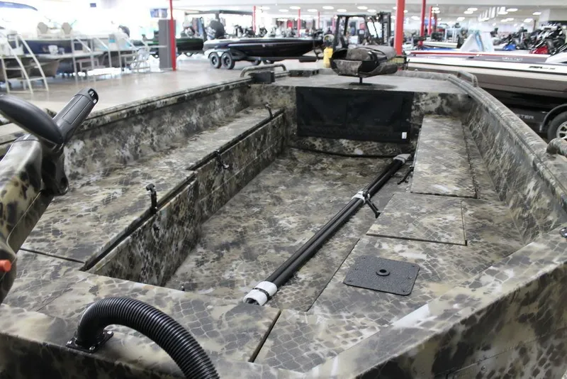 Slide: The Image of 2026 Excel 1860 Viper F4 boat with camouflage design on a trailer indoors. - 7