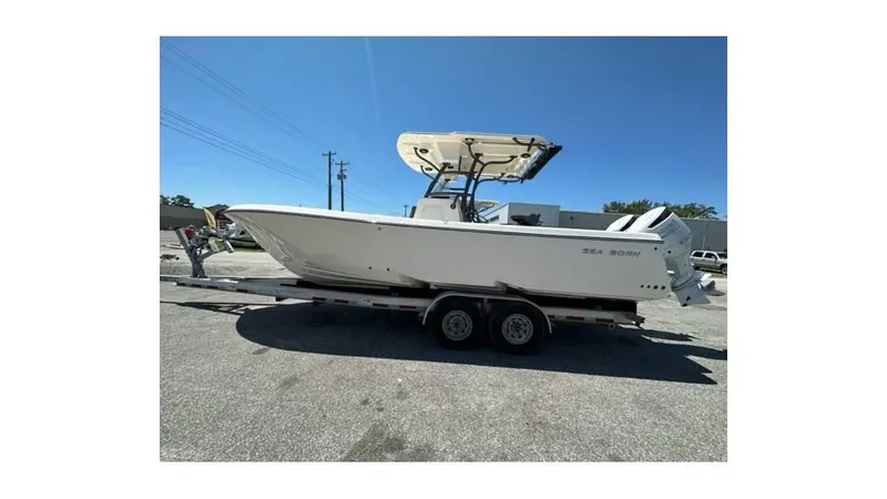 The Image of 2024 Sea Born FX25 Bay boat on trailer under clear blue sky. - 0