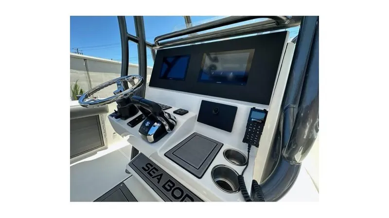 Slide: The Image of 2024 Sea Born FX25 Bay boat console with steering wheel and electronic displays. - 10