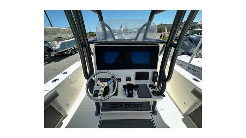 Slide: The Image of 2024 Sea Born FX25 Bay boat dashboard with steering wheel and digital displays. - 11