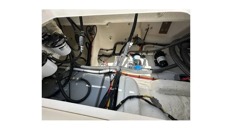 Slide: The Image of 2024 Sea Born FX25 Bay boat wiring and components in the engine compartment. - 17