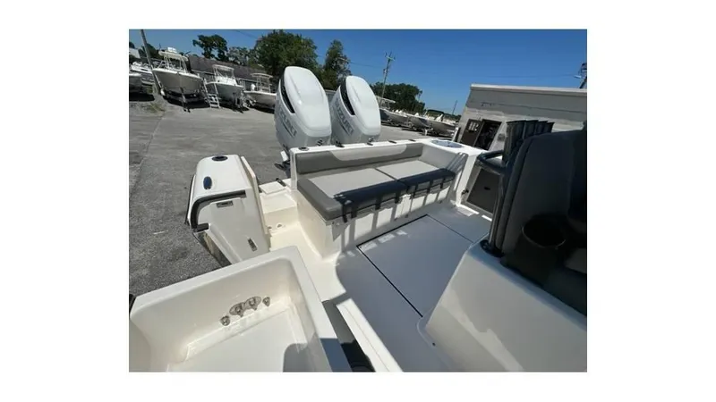 Slide: The Image of 2024 Sea Born FX25 Bay boat interior with dual engines and seating area. - 18