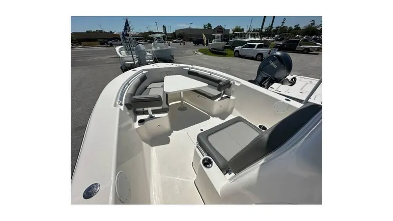 Slide: The Image of 2024 Sea Born FX25 Bay boat interior with seating and table in a parking lot. - 31