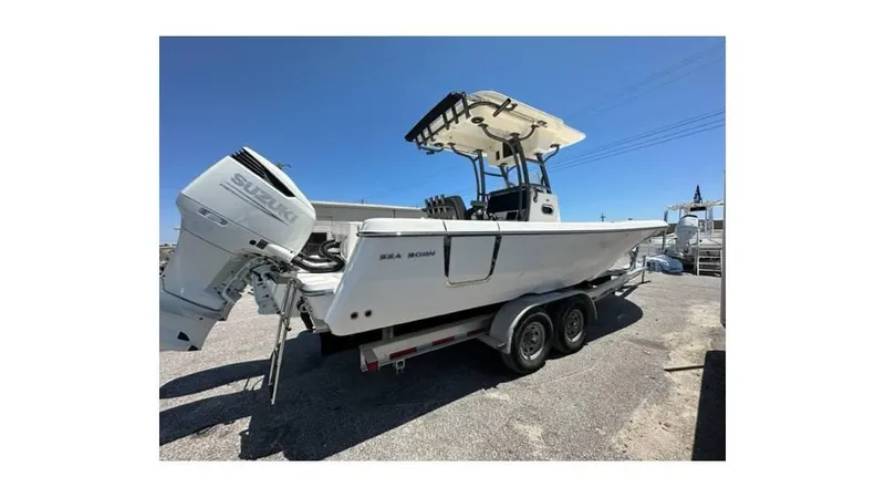 Slide: The Image of 2024 Sea Born FX25 Bay boat on trailer, featuring Suzuki outboard motor. - 32