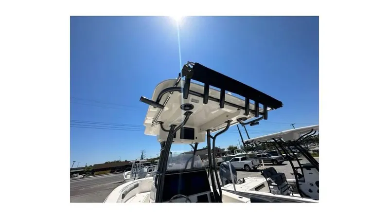 Slide: The Image of 2024 Sea Born FX25 Bay boat with T-top under clear blue sky. - 5