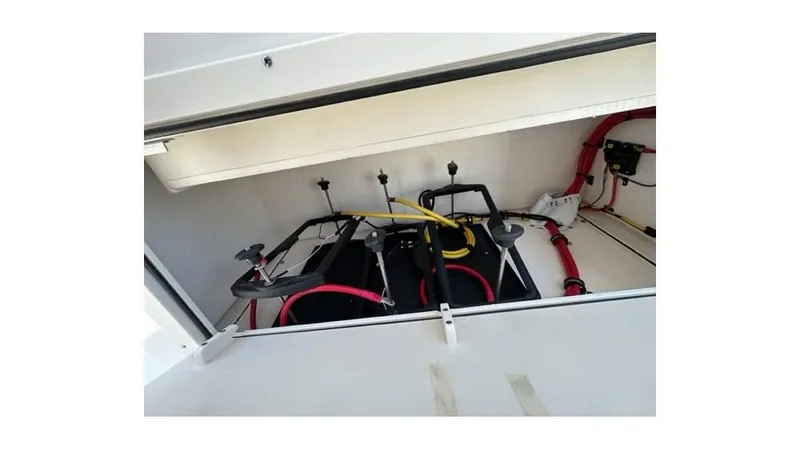 Slide: The Image of 2024 Sea Born FX25 Bay boat battery compartment with wiring and connections. - 8
