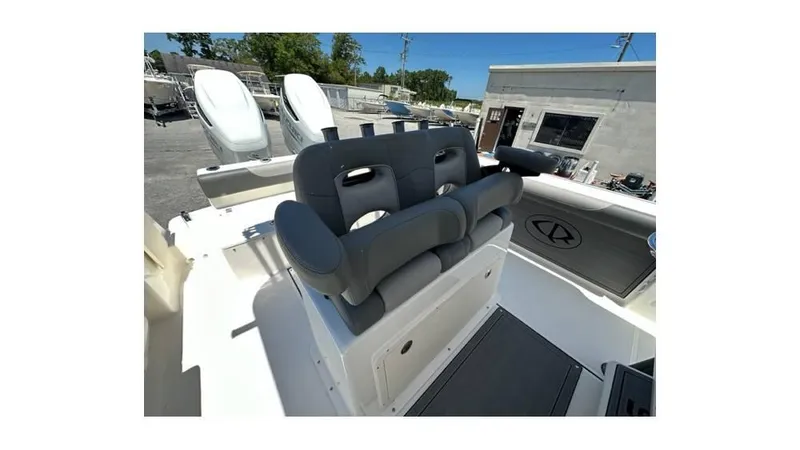 Slide: The Image of 2024 Sea Born FX25 Bay boat interior with cushioned seating and dual outboard motors. - 9