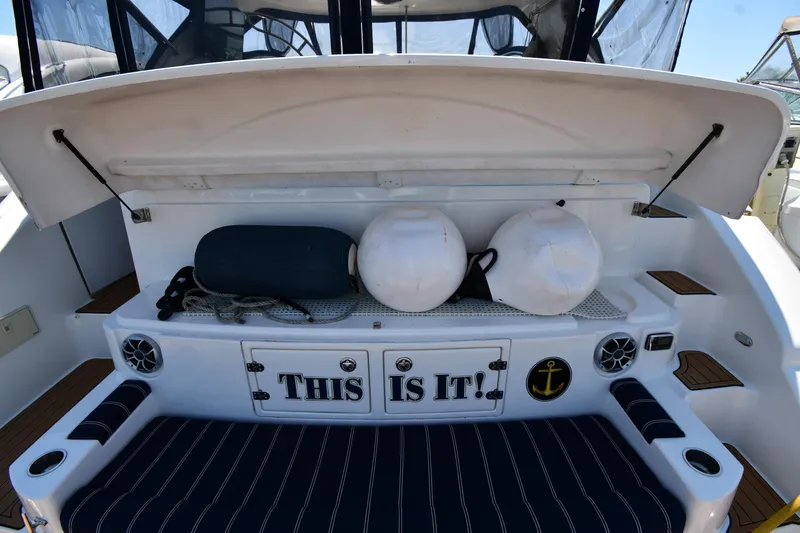 Slide: The Image of 2005 Cruisers Yachts 520 Express storage area with nautical equipment and This Is It! sign. - 11